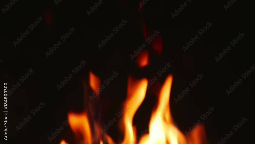Orange flames from burning logs in indor open fireplace in super slow motion. Orange flames from burning logs in indor open fireplace in super slow motion.
