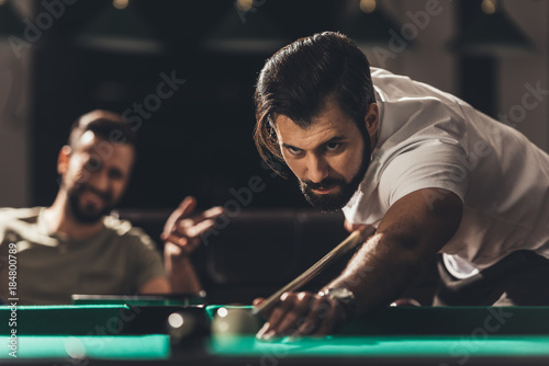handsome caucasian man playing in snooker photo