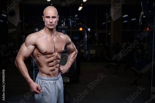 Brutal strong bodybuilder athletic men pumping up muscles with dumbbells