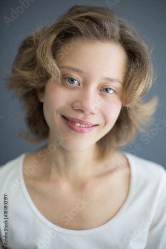 Portrait of beautiful smiling woman joyfully looking in camera isolated