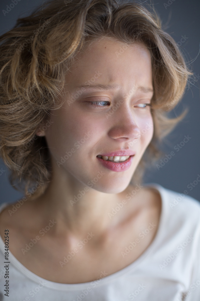 Portrait of crying lady frightenedly looking aside isolated Portrait of crying lady frightenedly looking aside isolated