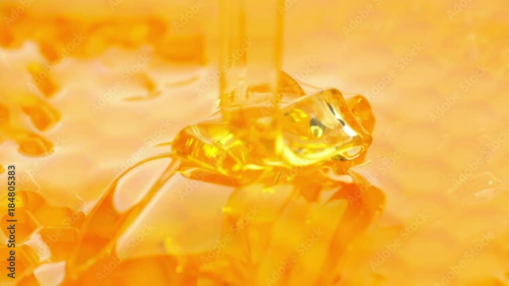 Pouring honey on honeycomb