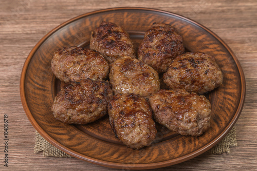 Homemade cutlets of meat in a ceramic bowl close-up. Brown