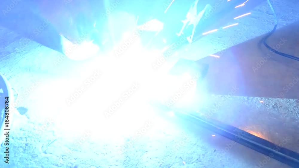 Worker,welding in a car  with sparks, manufacturing, industry