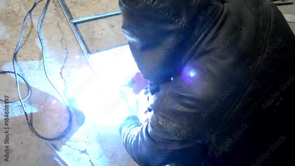 Worker,welding in a car  with sparks, manufacturing, industry