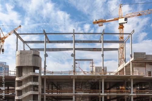 The process of building multi-storey parking for cars. Concrete interior of unfinished parking area