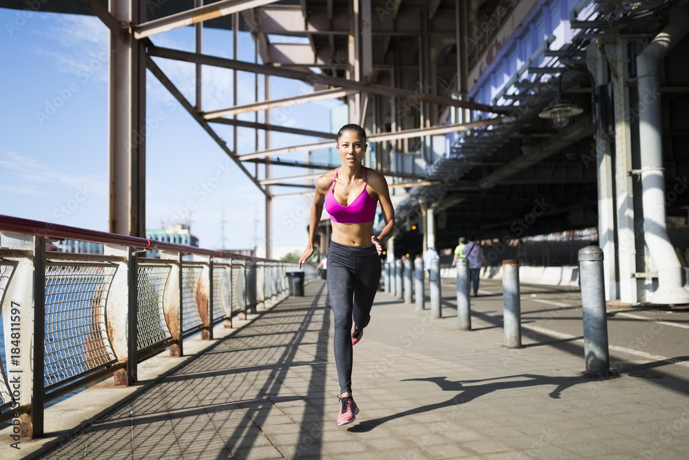 Woman jogging on bridge