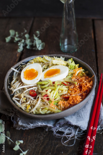Bowl of gluten free Udon noodle soup with carrots, Chinese cabbage, zoodles, mungo beans sprouts and boiled egg photo