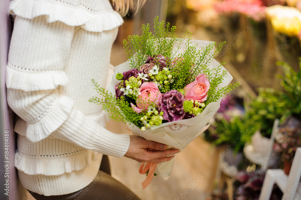 Woman dressed in a white sweater holding a pretty valentine bouquet Woman dressed in a white sweater holding a pretty valentine bouquet