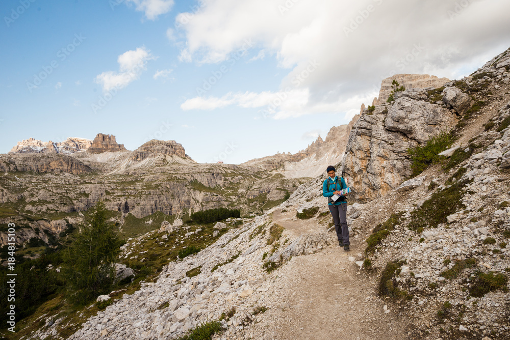 Young female is hiking in the Dolomites in Italy