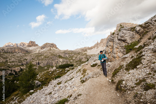 Young female is hiking in the Dolomites in Italy © blazekg