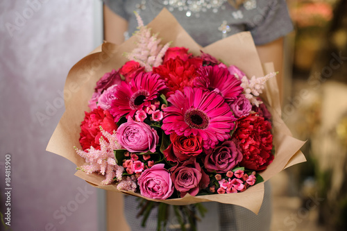 Woman holding a bright pink flower bouquet for Valentines day photo