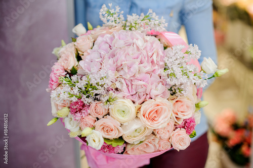 Wallpaper Mural Woman holding a large flower bouquet in pink tones for Valentine's day Torontodigital.ca