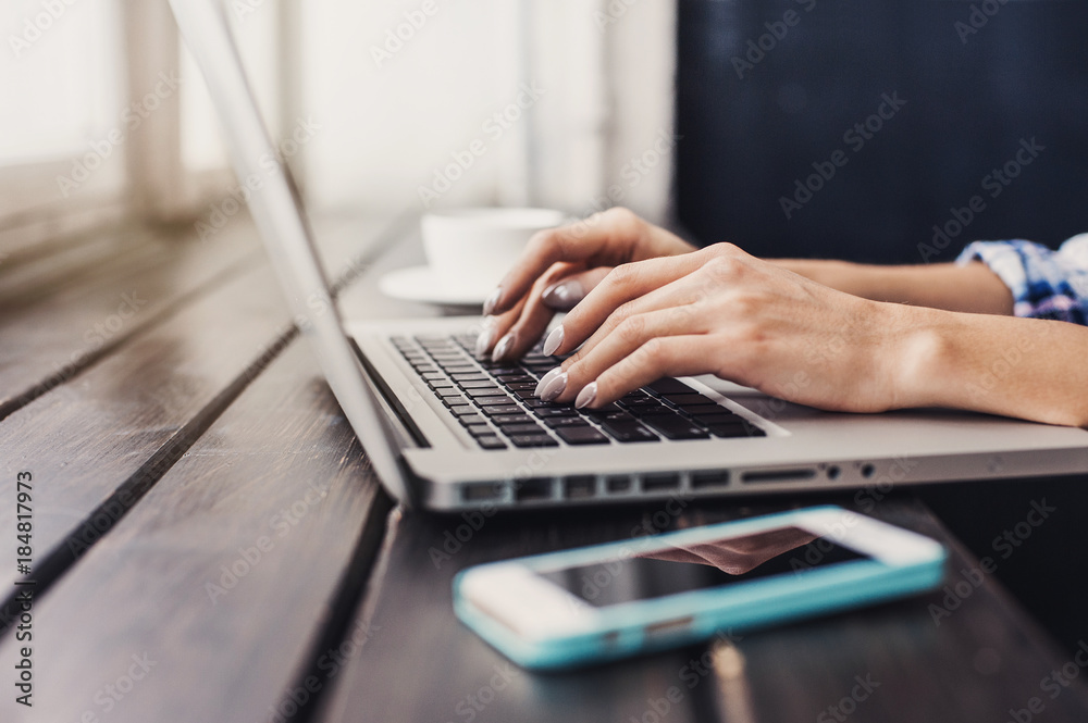 Business woman using laptop computer. Female hand typing on laptop keyboard