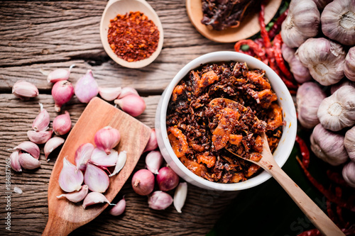 Fototapeta Naklejka Na Ścianę i Meble -  Chili paste Thai tradition style spicy dipping mad frop pork and shirmp with spicy and herb for ingredient on wooden texture table
