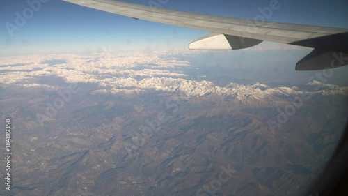 Aerial view of the Alps from the airplane. 4k photo