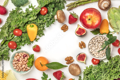 Vibrant fresh vegetables, fruits, cereals, and mushrooms on white background with copyspace