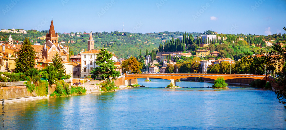 Fototapeta premium Beautiful old houses and Teatro Romano on Adige river in Verona, Veneto region, Italy.