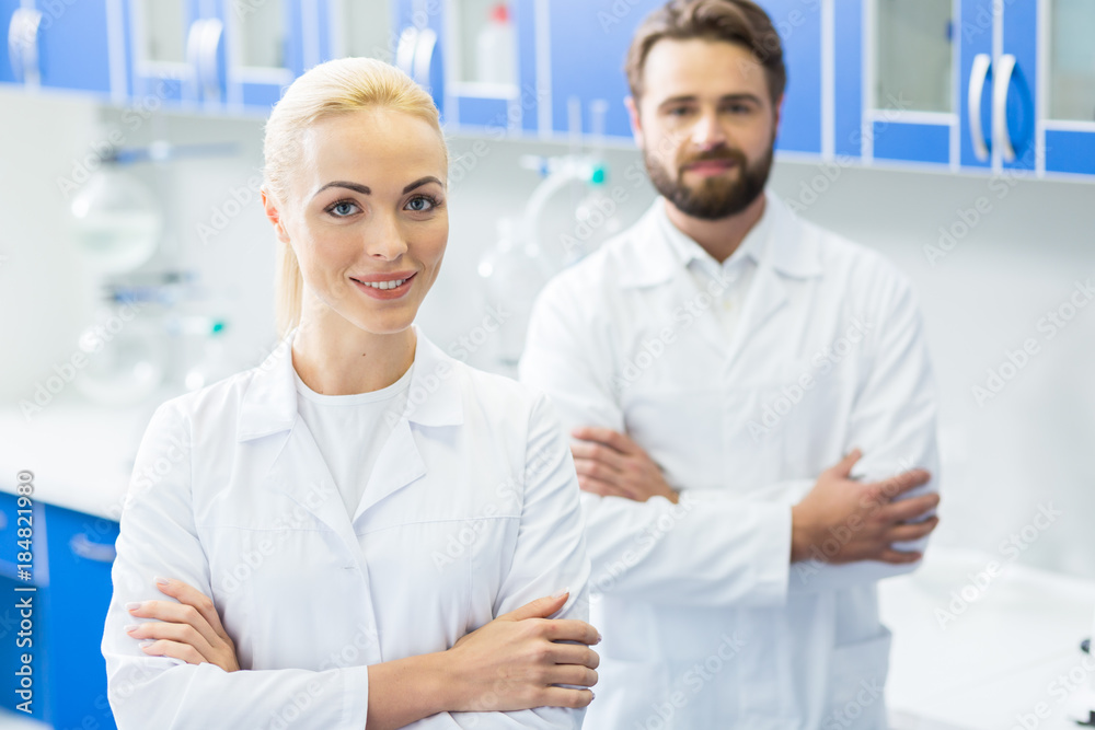 Delighted female researcher standing cross handed Delighted female researcher standing cross handed