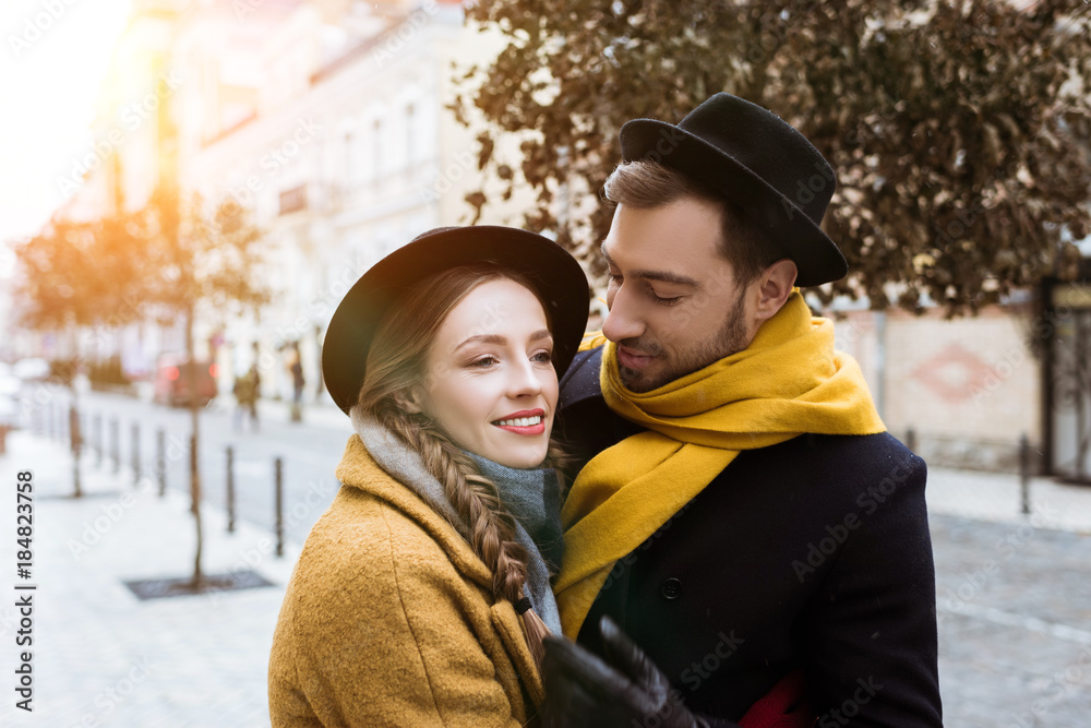 attractive young couple hugging in autumn outfit