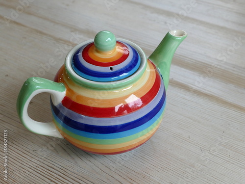 Colourful teapot on a wooden table