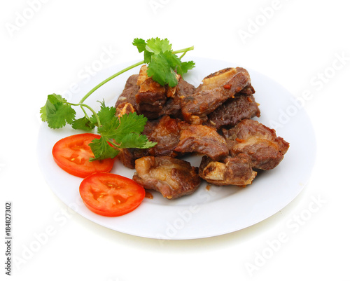 Grilled beef rib in plate on white
