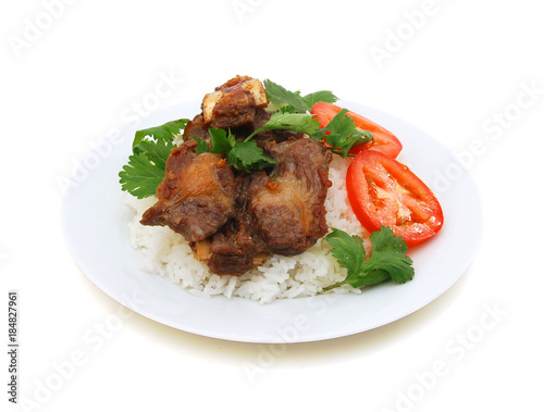 Grilled beef rib and rice in plate on white