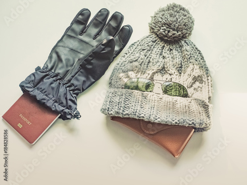 winter season travel flat lay concept from  winter cloth item and passport look like human say hello put on isolated white background