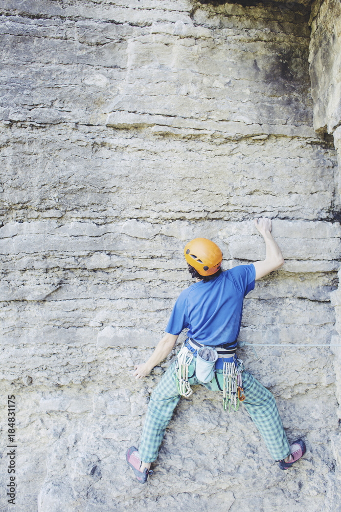 The climber climbs the rock.