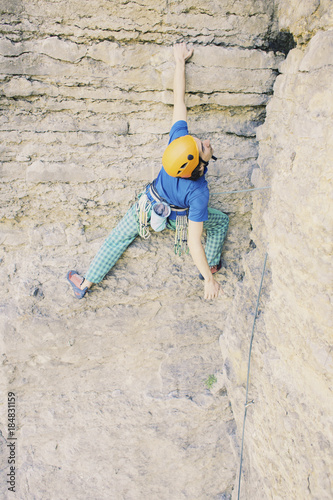 The climber climbs the rock.
