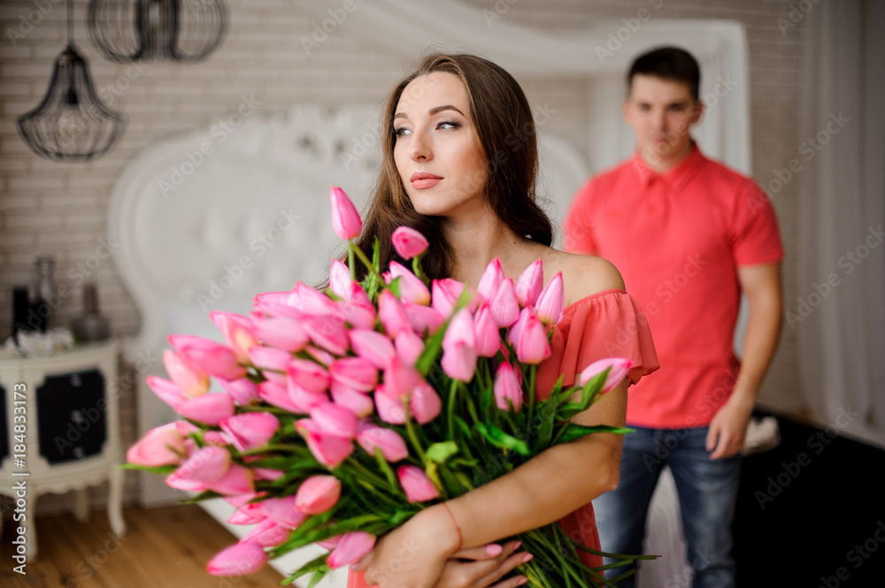 Young and lovely woman with big bouquet of tulips Young and lovely woman with big bouquet of tulips