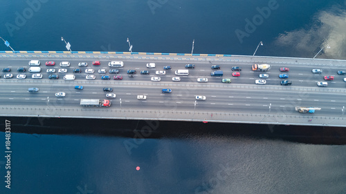 Aerial top view of bridge road automobile traffic of many cars from above, city transportation concept
