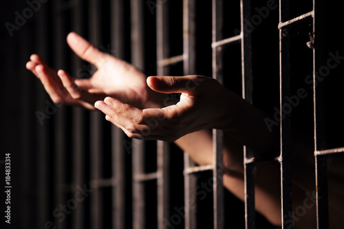 Fototapeta hands of prisoner in jail.