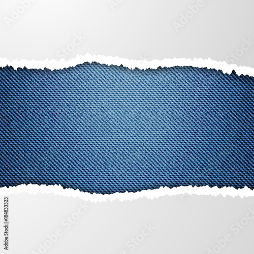 Ripped paper on denim background