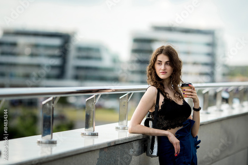 young beautiful stylish hipster woman  drinking coffee in paper cup