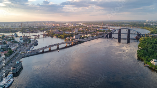 Aerial top view of Dnepr river and Rybalskiy island from above, bridges and skyline of Kiev city, Ukraine 