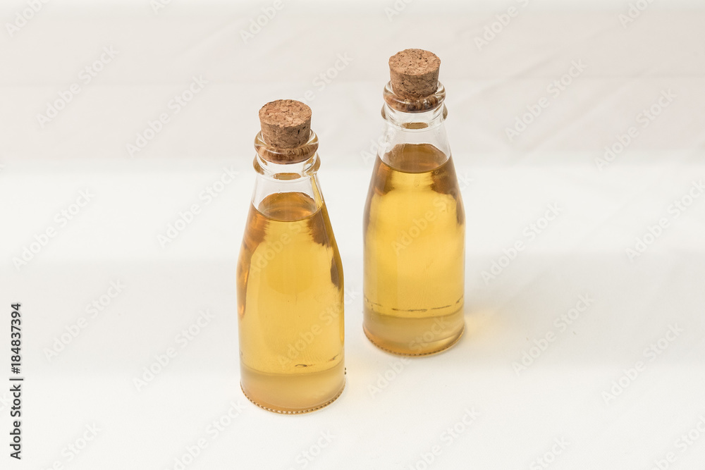 Oil in glass bottle with cork lid Oil in glass bottle with cork lid
