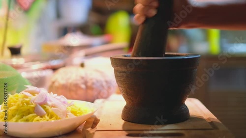 Pounding  granite mortar  and pestle   photo