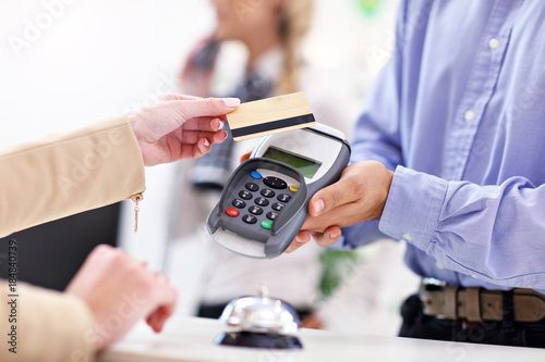 People paying in hotel reception