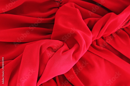 Red silk fabric background. Sexy red silk fabric as background cover. Sexy illustration. Silk closeup texture pattern symbol of sex or bed scene. Red silk dress macro photo. Artsy cover.
