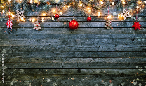 Christmas background with wooden decorations and spot lights.