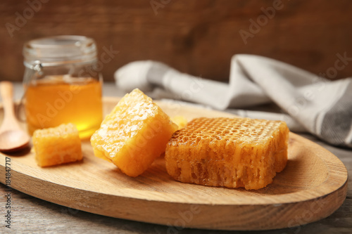 Fresh honeycombs on wooden board