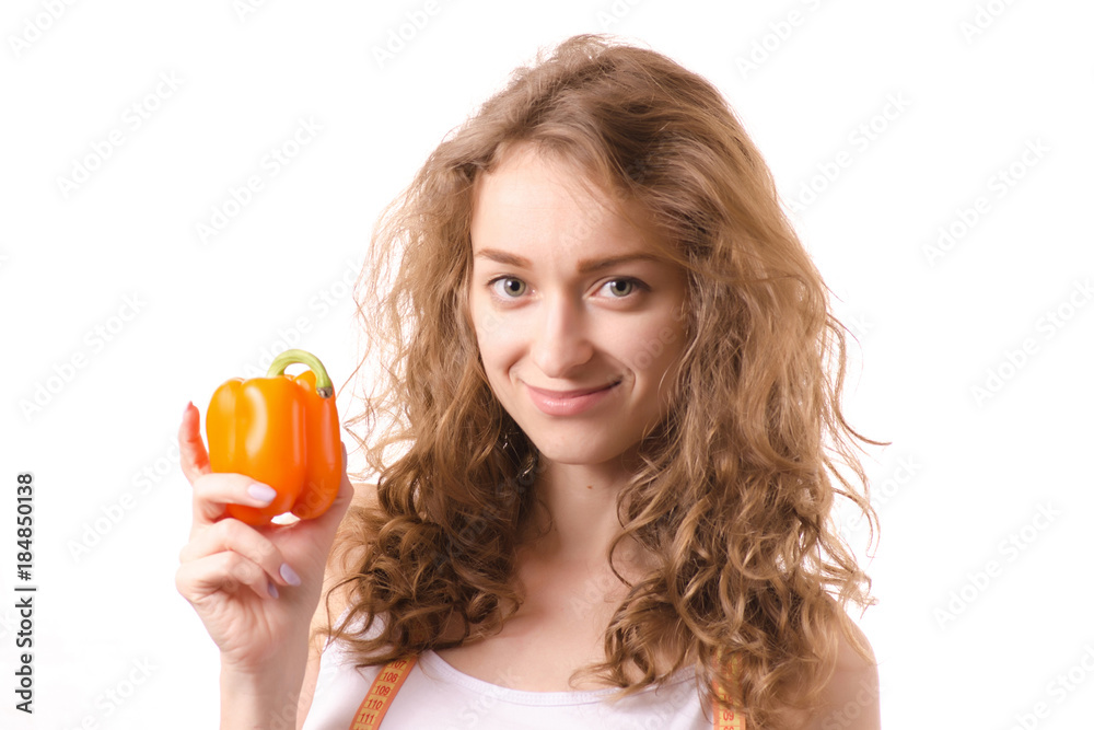 Beautiful young woman holding a pepper centimeter Beautiful young woman holding a pepper centimeter