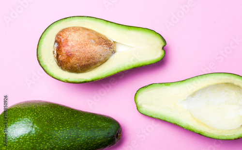 Avocado slices on pink background