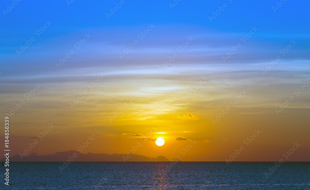 Blue sky with clouds and sun reflection in water ocean