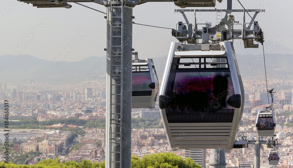 Cable Cars operating with a scenic cityscape of Barcelona, Catalonia, Spain.