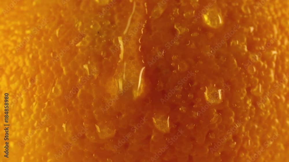Fresh Orange skin peel texture close up macro background with slow motion water droplet flowing down. Citrus Organic Healthy Food video