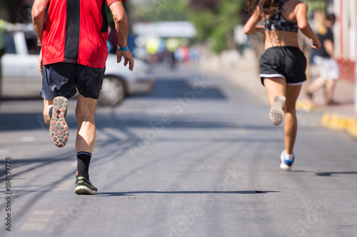 Men and woman runners running marathon street