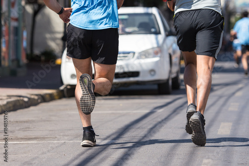 Men runners running marathon street