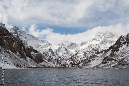 Snow covered mountains with a lake in the foreground in California.  © Rosemary